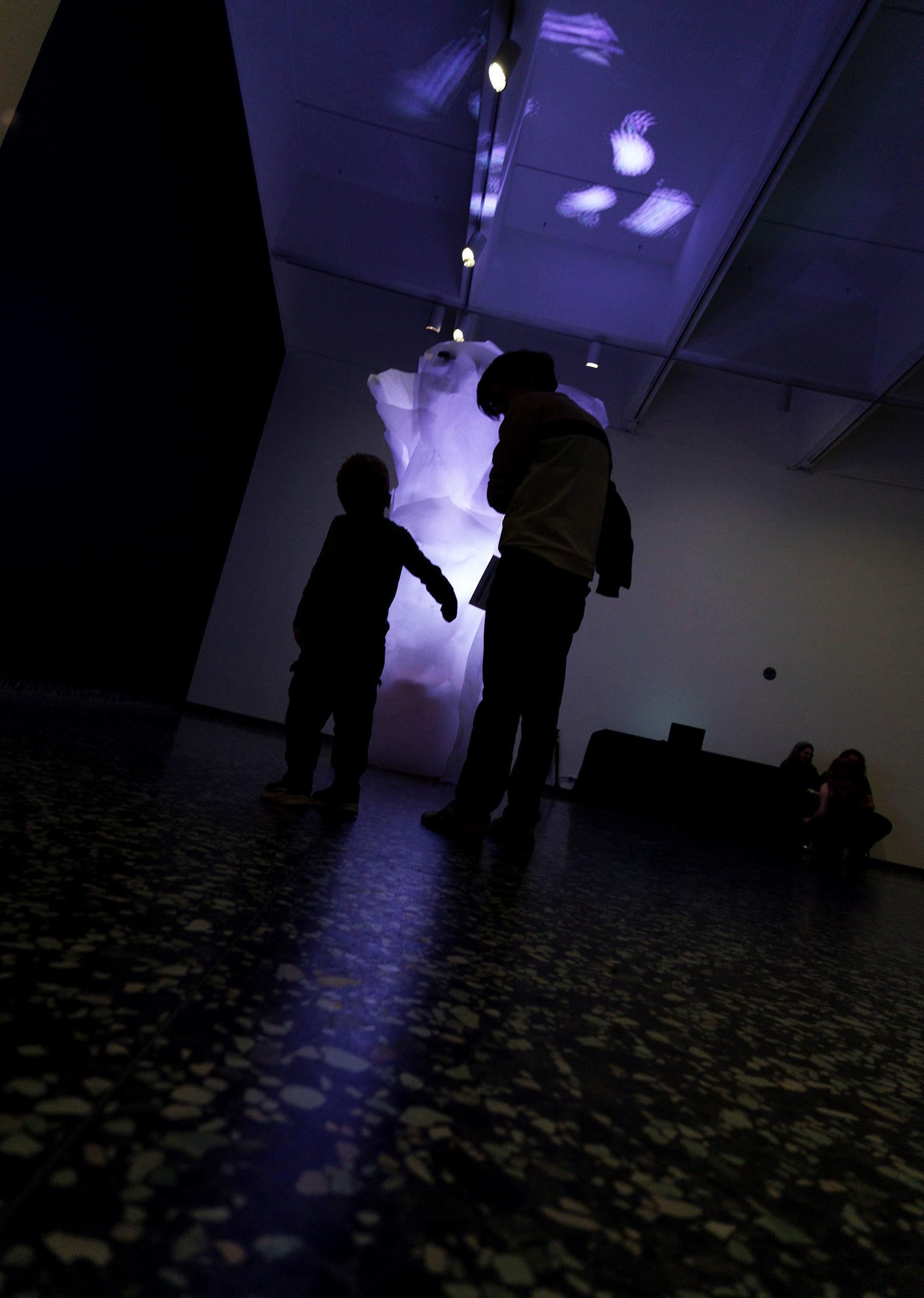 Tree of Life sculpture with two people occluding the light